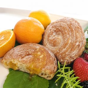 Close-up of Jarams Thanksgiving Apple Jam Croissant Roll, sliced to reveal apple jam filling.