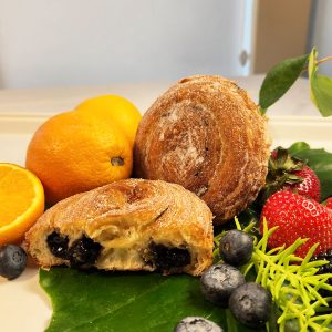 Close-up of Jarams Handcrafted Blueberry Jam Croissant Roll, showing the dark, pure blueberry jam filling.